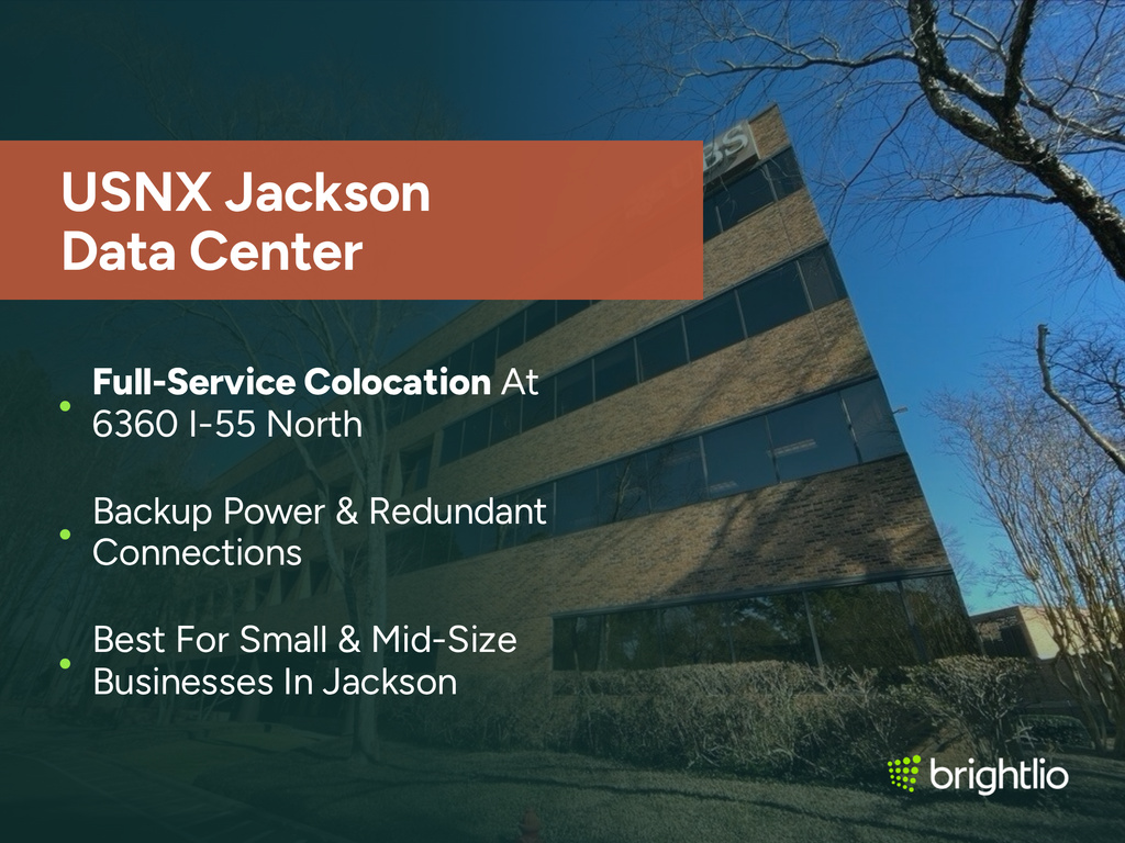 USNX Jackson Data Center graphic over a photo of the office building at 6360 I-55 North in Jackson, Mississippi, showing its four-storey brown brick facade with horizontal bands of tinted windows, bare winter trees and clipped hedges under a clear blue sky, beneath a dark teal overlay, highlighting full-service colocation at 6360 I-55 North, backup power and redundant connections, and suitability for small and mid-size businesses in Jackson, with the Brightlio logo